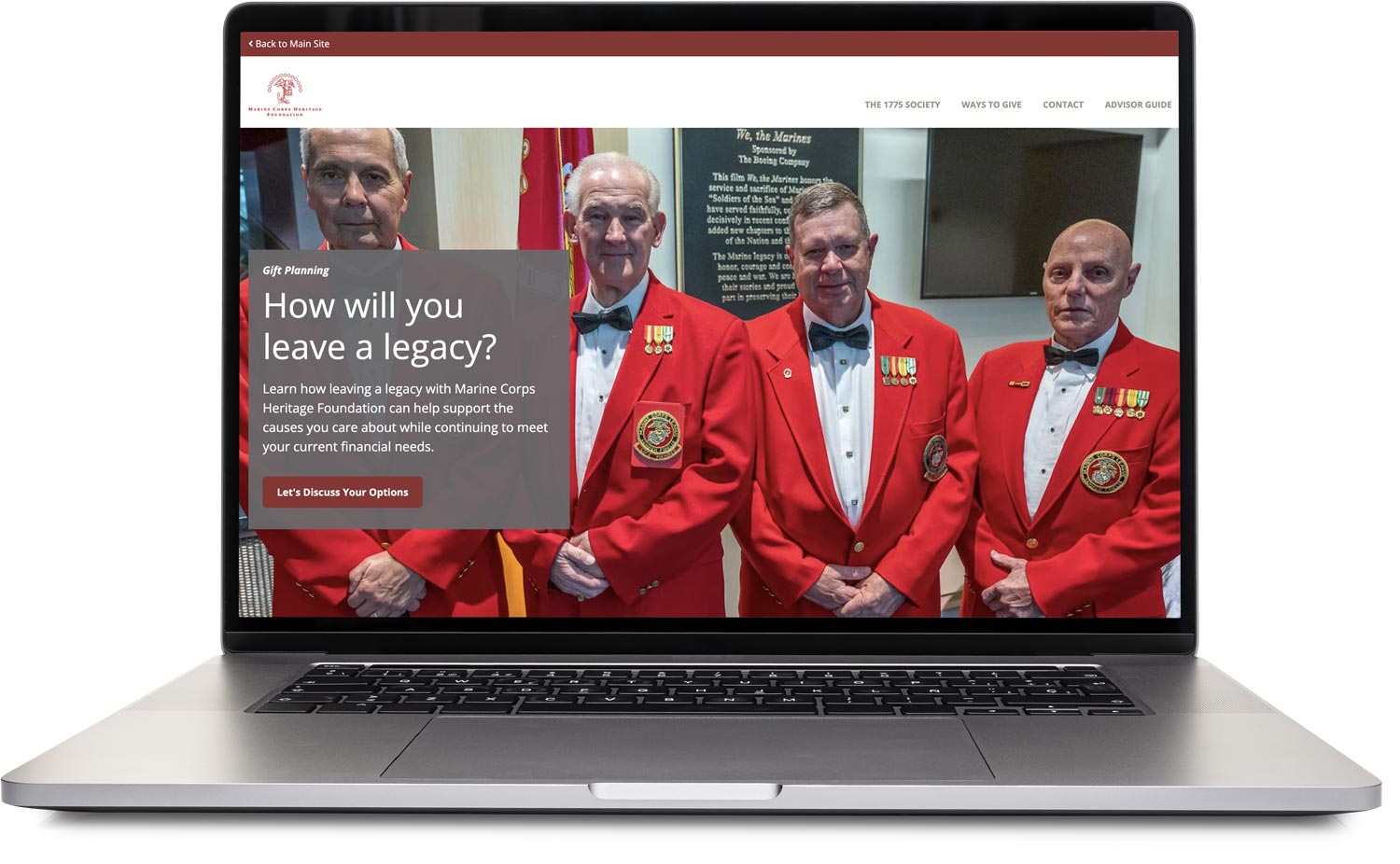 Laptop displaying a website with four men in red jackets and military medals standing side by side.